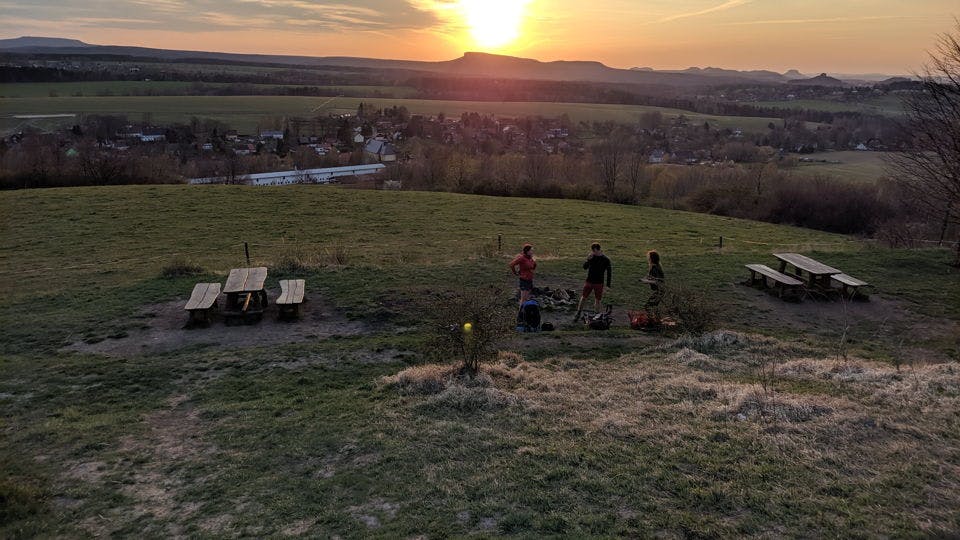 Sunset, two tables and group of people